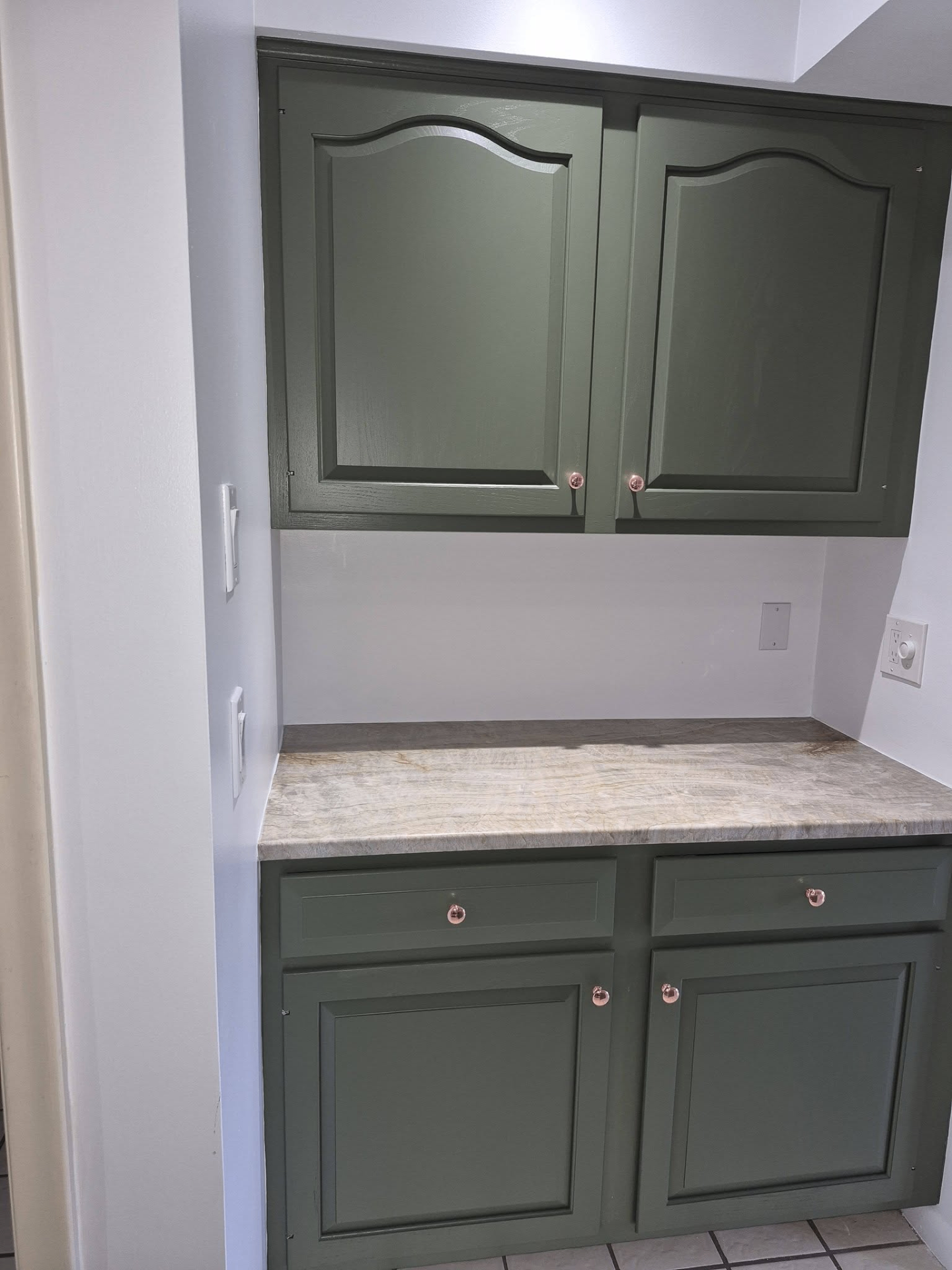 Built-in cabinet nook painted in sage green
