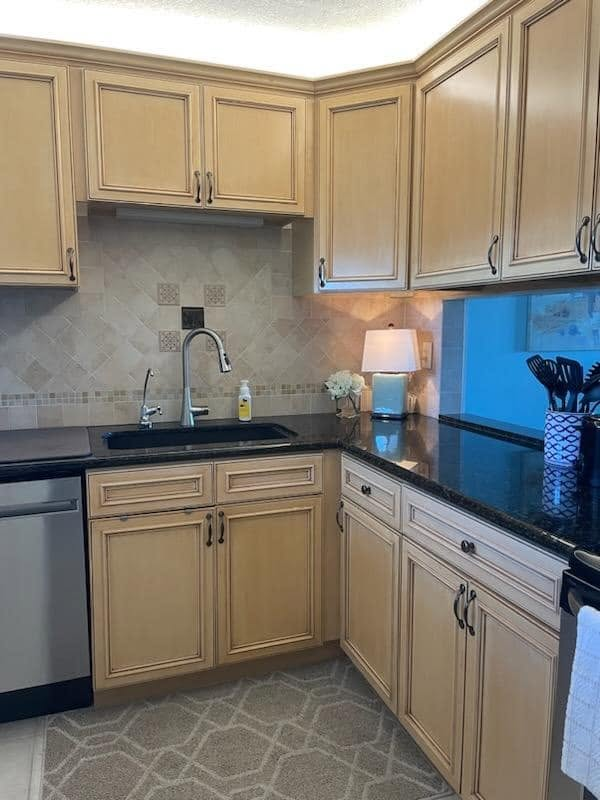 Glazed tan kitchen cabinetry with detailed finish