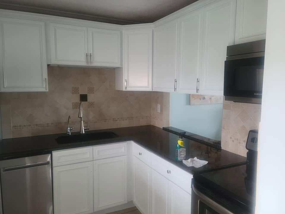 Kitchen cabinets refinished in crisp white