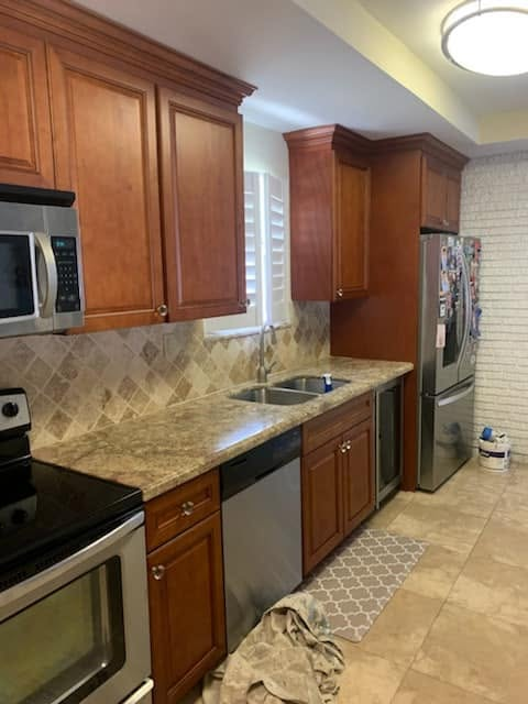 Galley kitchen with cherry cabinetry