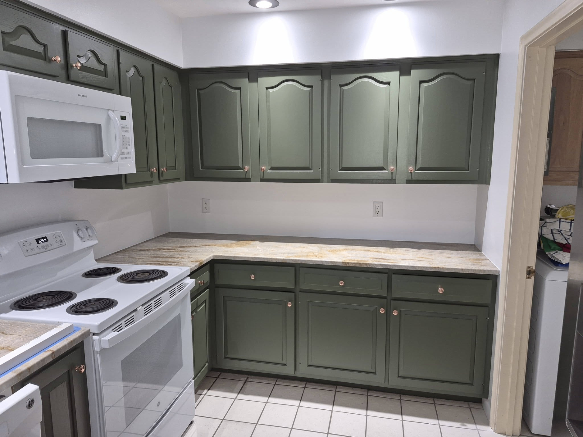 Detailed sage green kitchen cabinet refinishing
